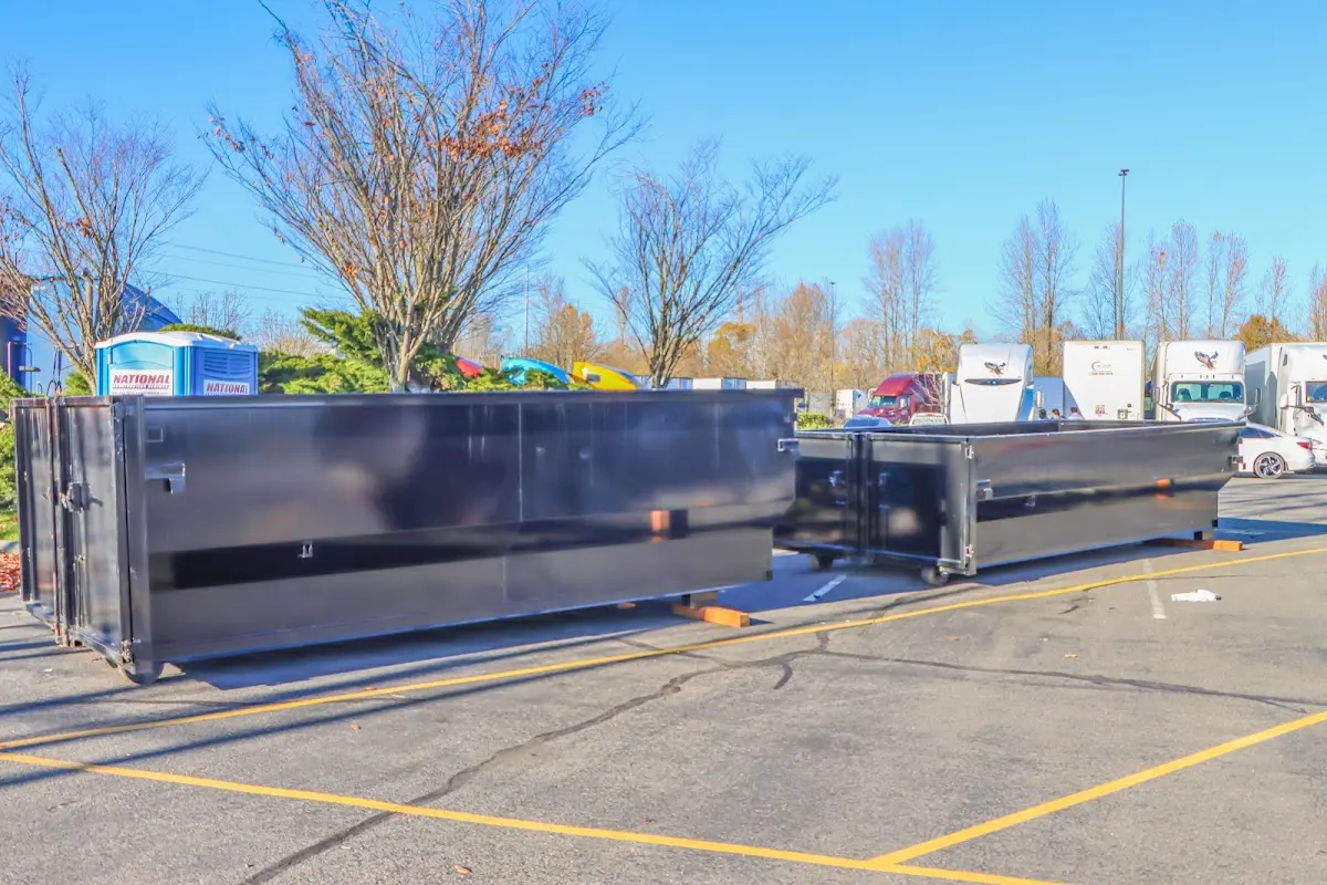 Professional dumpster rental service with roll-off container on residential driveway in Metairie